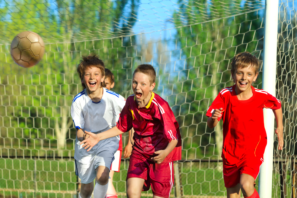 Little,Boys,Playing,Soccer,On,The,Sports,Field,Next,To